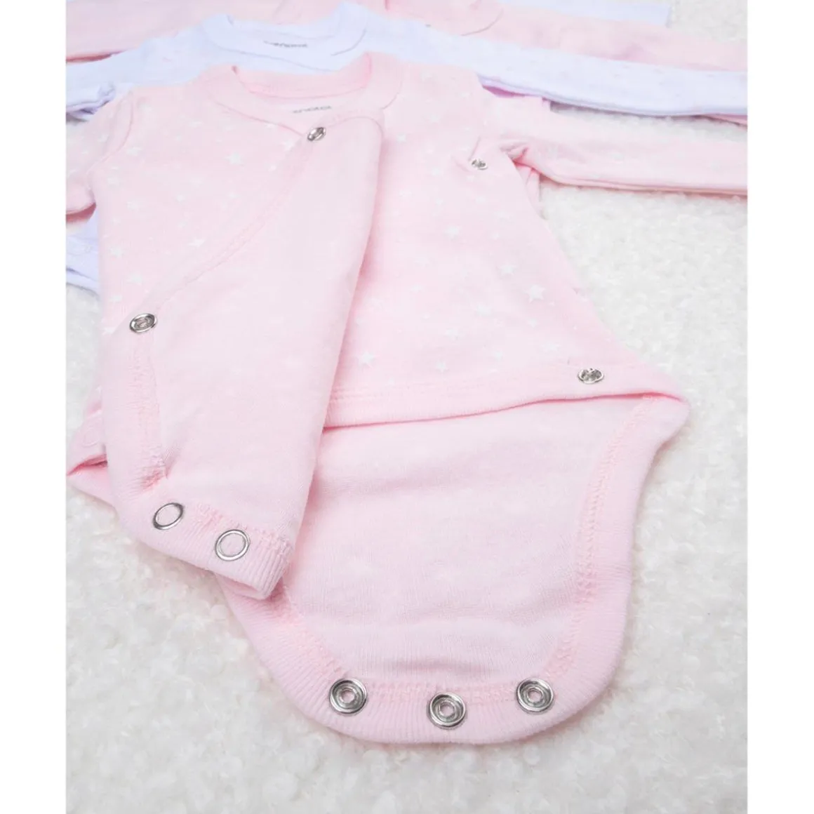 Pack de 5 bodies rosas, blancos y con estrellitas