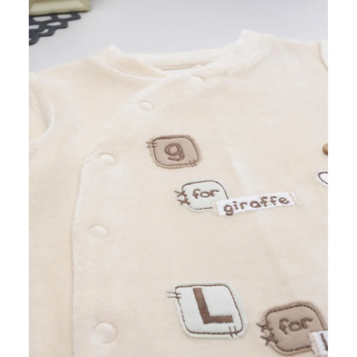 Pelele bebé beige jirafa/león